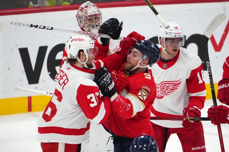 Jan 17, 2024; Sunrise, Florida, USA; Florida Panthers center Sam Bennett (9) and Detroit Red Wings right wing Christian Fischer (36) exchange jabs while in a scrum during the first period at Amerant Bank Arena. Mandatory Credit: Jasen Vinlove-USA TODAY Sports