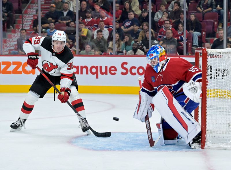 Sep 24, 2024; Montreal, Quebec, CAN; Montreal Canadiens goalie Connor Hughes (95) makes a save in front of New Jersey Devils forward Mike Hardman (39) during the second period at the Bell Centre. Mandatory Credit: Eric Bolte-Imagn Images