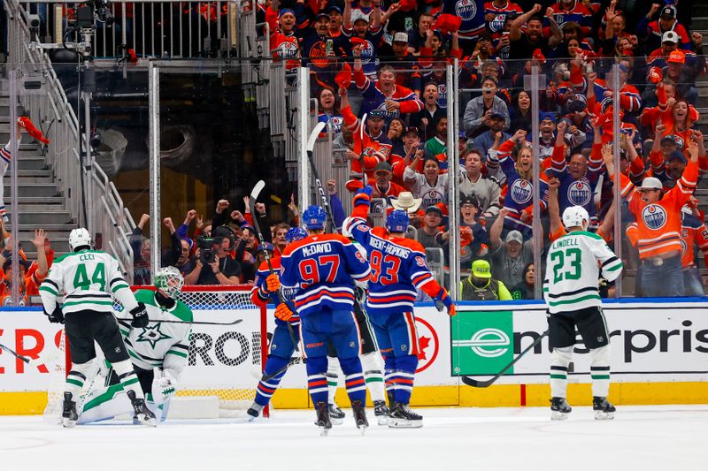 May 27, 2025; Edmonton, Alberta, CAN; Edmonton Oilers right wing Corey Perry (90) and center Connor McDavid (97) and center Ryan Nugent-Hopkins (93) celebrates a power play goal scored by Perry against the Dallas Stars during the second period in game four of the Western Conference Final of the 2025 Stanley Cup Playoffs at Rogers Place. Mandatory Credit: Perry Nelson-Imagn Images