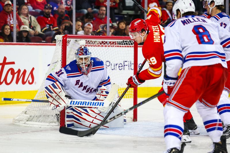 Oct 26, 2025; Calgary, Alberta, CAN; New York Rangers goaltender Igor Shesterkin (31) makes a save against the Calgary Flames during the second period at Scotiabank Saddledome. Mandatory Credit: Sergei Belski-Imagn Images
