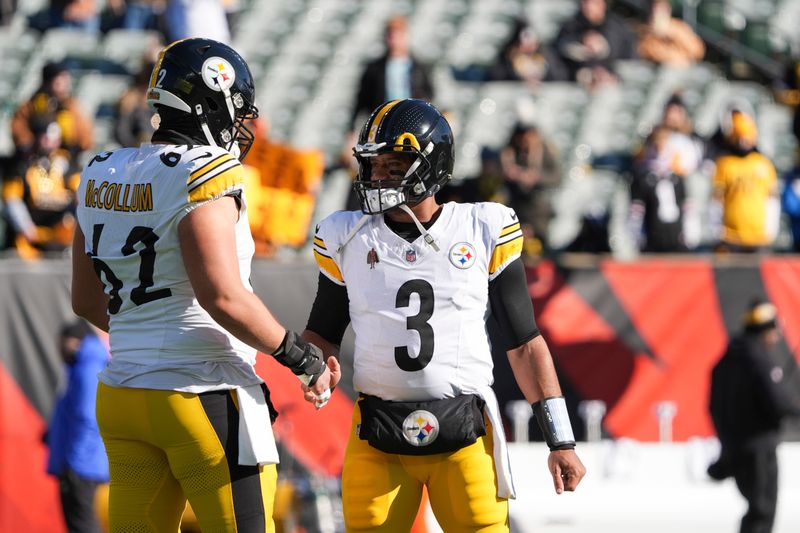 Pittsburgh Steelers quarterback Russell Wilson (3) and center Ryan McCollum warm up before an NFL football game against the Cincinnati Bengals, Sunday, Dec. 1, 2024, in Cincinnati. (AP Photo/Joshua A. Bickel)