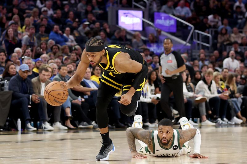 SAN FRANCISCO, CALIFORNIA - MARCH 06: Moses Moody #4 of the Golden State Warriors steals the ball from Damian Lillard #0 of the Milwaukee Bucks in the second half at Chase Center on March 06, 2024 in San Francisco, California. NOTE TO USER: User expressly acknowledges and agrees that, by downloading and or using this photograph, User is consenting to the terms and conditions of the Getty Images License Agreement.  (Photo by Ezra Shaw/Getty Images)