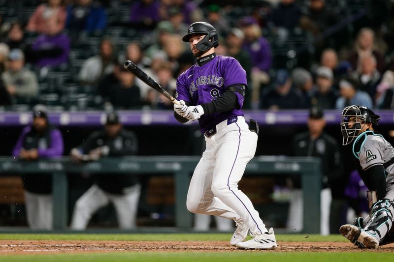 Apr 8, 2024; Denver, Colorado, USA; Colorado Rockies center fielder Brenton Doyle (9) watches his ball on a double in the sixth inning against the Arizona Diamondbacks at Coors Field. Mandatory Credit: Isaiah J. Downing-USA TODAY Sports