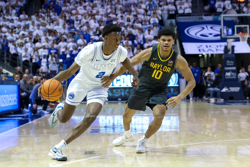 Feb 20, 2024; Provo, Utah, USA; Brigham Young Cougars guard Jaxson Robinson (2) drives the ball against Baylor Bears guard RayJ Dennis (10) during the second half at Marriott Center. Mandatory Credit: Rob Gray-USA TODAY Sports