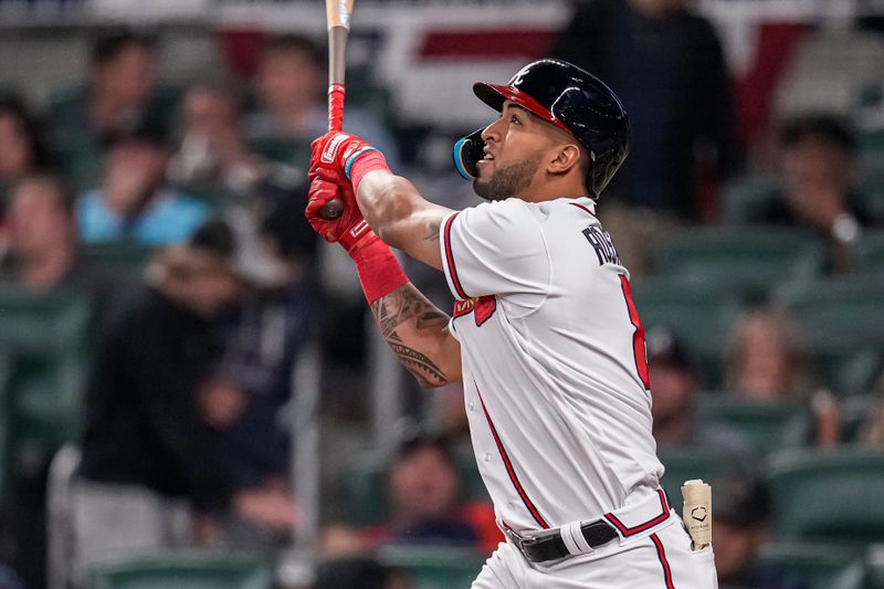 Apr 12, 2023; Cumberland, Georgia, USA; Atlanta Braves left fielder Eddie Rosario (8) watches the ball after hitting a home run against the Cincinnati Reds during the eighth inning at Truist Park. Mandatory Credit: Dale Zanine-USA TODAY Sports