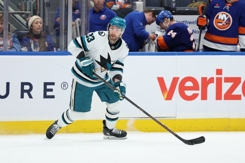 Jan 18, 2025; Elmont, New York, USA;  San Jose Sharks right wing Barclay Goodrow (23) looks to move the puck against the New York Islanders during the third period at UBS Arena. Mandatory Credit: Thomas Salus-Imagn Images