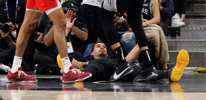 SAN ANTONIO, TX - JANUARY  26:  Victor Wembanyama #1 of the San Antonio Spurs looks up after making a foul on the Portland Trailblazers in the second half at Frost Bank Center on January 26, 2024 in San Antonio, Texas. NOTE TO USER: User expressly acknowledges and agrees that, by downloading and or using this photograph, User is consenting to terms and conditions of the Getty Images License Agreement. (Photo by Ronald Cortes/Getty Images)