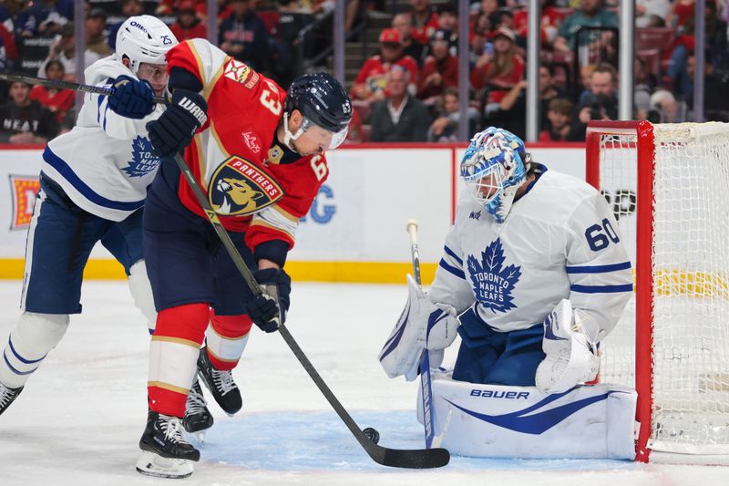 Apr 8, 2025; Sunrise, Florida, USA; Toronto Maple Leafs goaltender Joseph Woll (60) makes a save against Florida Panthers center Brad Marchand (63) during the second period at Amerant Bank Arena. Mandatory Credit: Sam Navarro-Imagn Images