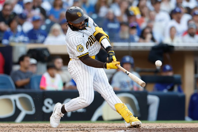 Jul 31, 2024; San Diego, California, USA; San Diego Padres catcher Luis Campusano (12) hits a home run during the fourth inning against the Los Angeles Dodgers at Petco Park. Mandatory Credit: David Frerker-USA TODAY Sports