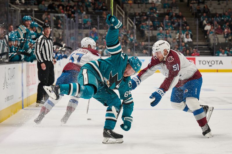 Oct 20, 2024; San Jose, California, USA; San Jose Sharks center Mikael Granlund (64) loses his balance as he forechecks against Colorado right wing Nikolai Kovalenko (51) during the first period at SAP Center at San Jose. Mandatory Credit: Robert Edwards-Imagn Images