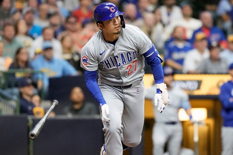 May 28, 2024; Milwaukee, Wisconsin, USA;  Chicago Cubs right fielder Seiya Suzuki (27) drops his bat after hitting a single during the tenth inning against the Milwaukee Brewers at American Family Field. Mandatory Credit: Jeff Hanisch-USA TODAY Sports