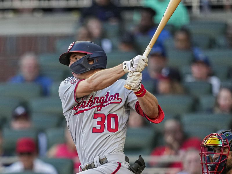 Oct 1, 2023; Cumberland, Georgia, USA; Washington Nationals outfielder Jacob Young (30) drives in a run with a ground ball against the Atlanta Braves during the ninth inning at Truist Park. Mandatory Credit: Dale Zanine-USA TODAY Sports