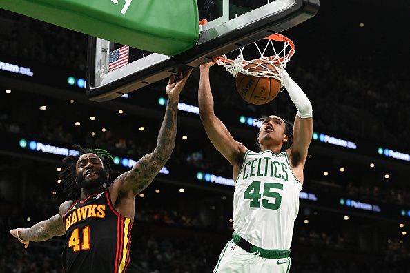 BOSTON, MASSACHUSETTS - NOVEMBER 26: Dalano Banton #45 of the Boston Celtics dunks and scores in front of Saddiq Bey #41 of the Atlanta Hawks during the third quarter at the TD Garden on November 26, 2023 in Boston, Massachusetts. NOTE TO USER: User expressly acknowledges and agrees that, by downloading and or using this photograph, User is consenting to the terms and conditions of the Getty Images License Agreement. (Photo by Brian Fluharty/Getty Images)