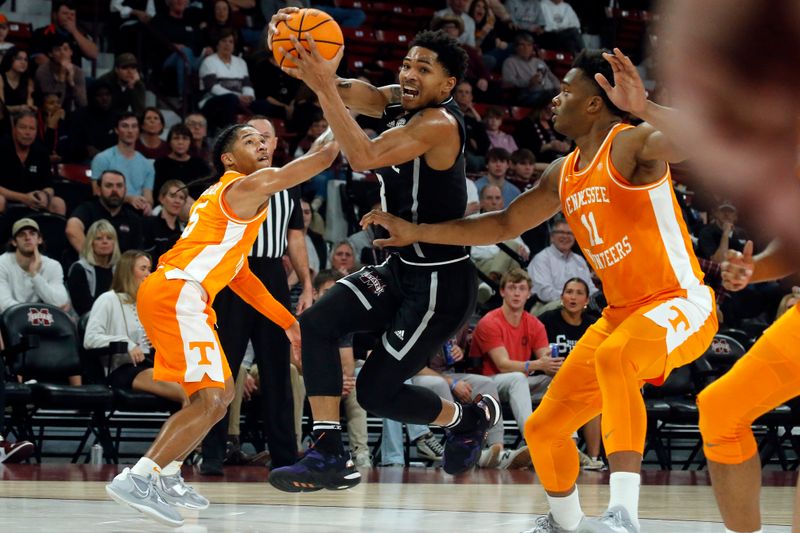 Jan 17, 2023; Starkville, Mississippi, USA; Mississippi State Bulldogs guard Shakeel Moore (3) drives to the basket between Tennessee Volunteers guard Zakai Zeigler (5) and forward Tobe Awaka (11) during the second half at Humphrey Coliseum. Mandatory Credit: Petre Thomas-USA TODAY Sports