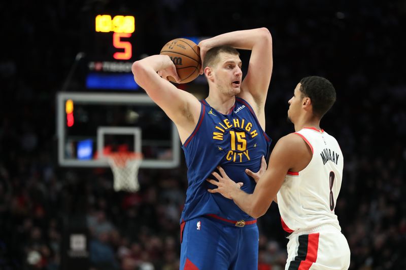 PORTLAND, OREGON - FEBRUARY 23: Nikola Jokic #15 of the Denver Nuggets looks to pass away from Kris Murray #8 of the Portland Trail Blazers during the third quarter at Moda Center on February 23, 2024 in Portland, Oregon. NOTE TO USER: User expressly acknowledges and agrees that, by downloading and or using this photograph, User is consenting to the terms and conditions of the Getty Images License Agreement.? (Photo by Amanda Loman/Getty Images)