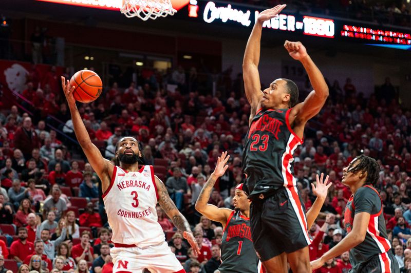 Jan 23, 2024; Lincoln, Nebraska, USA; Nebraska Cornhuskers guard Brice Williams (3) shoots the ball against Ohio State Buckeyes guard Roddy Gayle Jr. (1) and forward Zed Key (23) during the first half at Pinnacle Bank Arena. Mandatory Credit: Dylan Widger-USA TODAY Sports