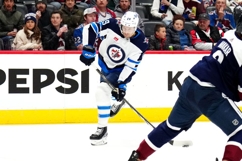 Dec 7, 2023; Denver, Colorado, USA; Winnipeg Jets center David Gustafsson (19) shoots the puck in the first period against the Colorado Avalanche at Ball Arena. Mandatory Credit: Ron Chenoy-USA TODAY Sports