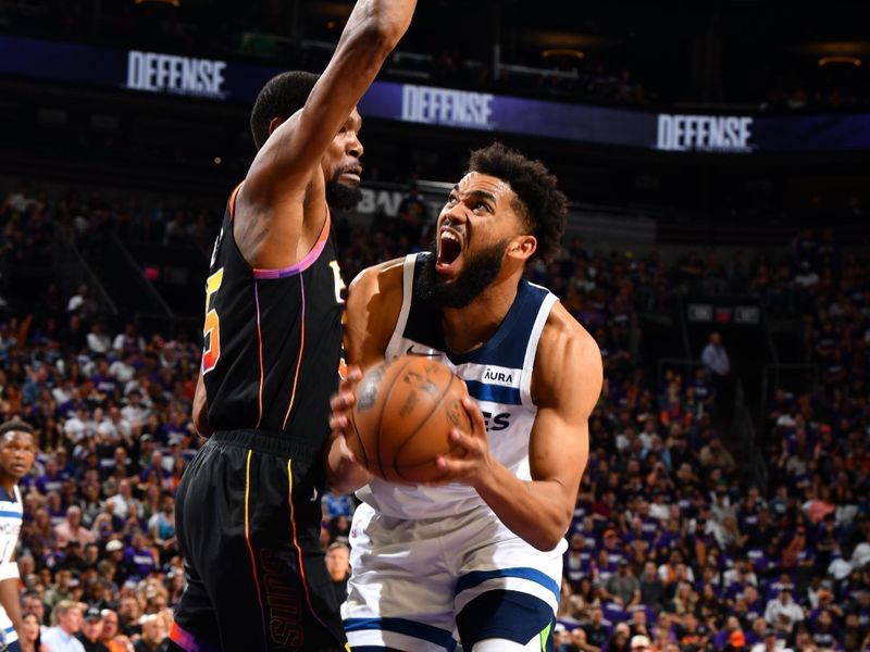 PHOENIX, AZ - APRIL 4: Karl-Anthony Towns #32 of the Minnesota Timberwolves handles the ball during the game against the Phoenix Suns during Round 1 Game 4 of the 2024 NBA Playoffs on April 4, 2023 at Footprint Center in Phoenix, Arizona. NOTE TO USER: User expressly acknowledges and agrees that, by downloading and or using this photograph, user is consenting to the terms and conditions of the Getty Images License Agreement. Mandatory Copyright Notice: Copyright 2024 NBAE (Photo by Barry Gossage/NBAE via Getty Images)