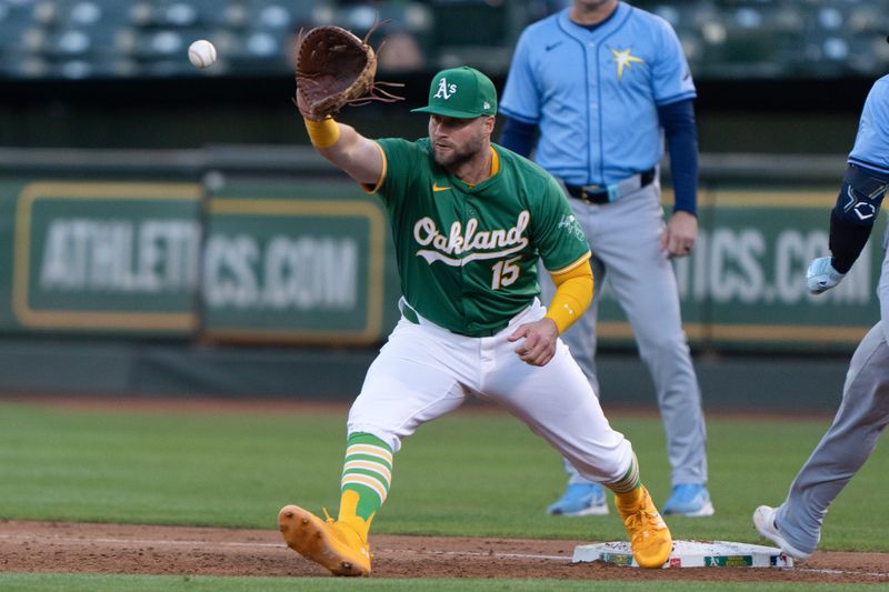 Aug 19, 2024; Oakland, California, USA; Oakland Athletics outfielder Seth Brown (15) catches the ball during the third inning against the Tampa Bay Rays at Oakland-Alameda County Coliseum. Mandatory Credit: Stan Szeto-USA TODAY Sports