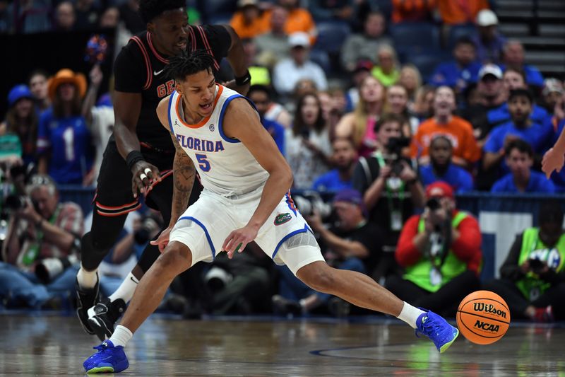 Mar 14, 2024; Nashville, TN, USA; Florida Gators guard Will Richard (5) tries to pick up a loose ball during the first half against the Georgia Bulldogs at Bridgestone Arena. Mandatory Credit: Christopher Hanewinckel-USA TODAY Sports