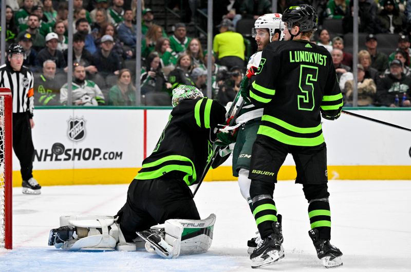 Jan 10, 2024; Dallas, Texas, USA; Dallas Stars goaltender Scott Wedgewood (41) and defenseman Nils Lundkvist (5) and Minnesota Wild right wing Ryan Hartman (38) look for the puck during the third period at the American Airlines Center. Mandatory Credit: Jerome Miron-USA TODAY Sports