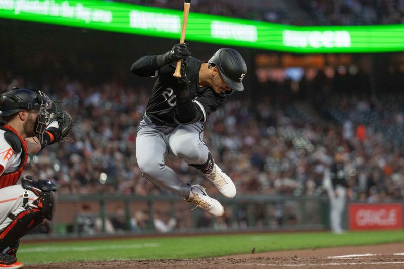 Aug 20, 2024; San Francisco, California, USA;  Chicago White Sox outfielder Miguel Vargas (20) leaps in an attempt to dodge the pitch during the fifth inning against the San Francisco Giants at Oracle Park. Mandatory Credit: Stan Szeto-USA TODAY Sports