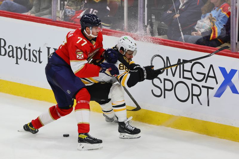 Oct 8, 2024; Sunrise, Florida, USA; Florida Panthers defenseman Niko Mikkola (77) and Boston Bruins right wing David Pastrnak (88) battle for the puck during the third period at Amerant Bank Arena. Mandatory Credit: Sam Navarro-Imagn Images