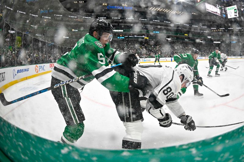 Jan 16, 2024; Dallas, Texas, USA; Dallas Stars defenseman Nils Lundkvist (5) checks Los Angeles Kings center Pierre-Luc Dubois (80) from behind as their skates kick up ice and snow during the third period at the American Airlines Center. Mandatory Credit: Jerome Miron-USA TODAY Sports