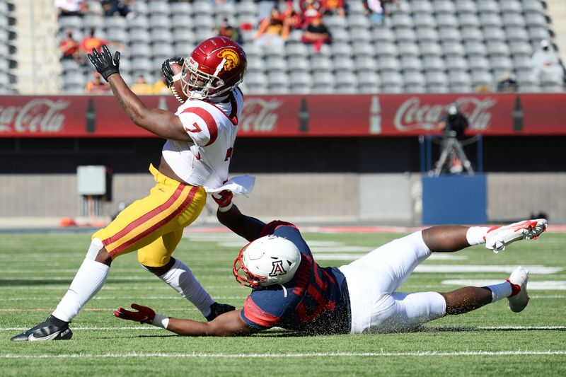 Nov 14, 2020; Tucson, Arizona, USA; USC Trojans running back Stephen Carr (7) is tackled by Arizona Wildcats linebacker Jalen Harris (49) during the first half at Arizona Stadium. Mandatory Credit: Joe Camporeale-USA TODAY Sports
