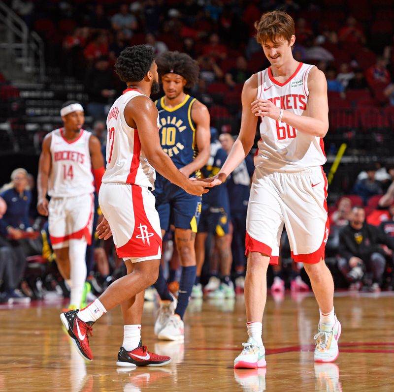 HOUSTON, TX - OCTOBER 10: Trevor Hudgins #12 and Matthew Mayer #60 of the Houston Rockets high five during the game against the Indiana Pacers on October 10, 2023 at the Toyota Center in Houston, TX. NOTE TO USER: User expressly acknowledges and agrees that, by downloading and or using this photograph, User is consenting to the terms and conditions of the Getty Images License Agreement. Mandatory Copyright Notice: Copyright 2023 NBAE (Photo by Logan Riely/NBAE via Getty Images)