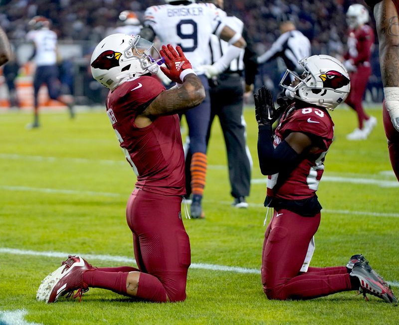 Arizona Cardinals running back James Conner, left, celebrates his touchdown with wide receiver Greg Dortch during the first half of an NFL football game against the Chicago Bears Sunday, Dec. 24, 2023, in Chicago. (AP Photo/Erin Hooley)