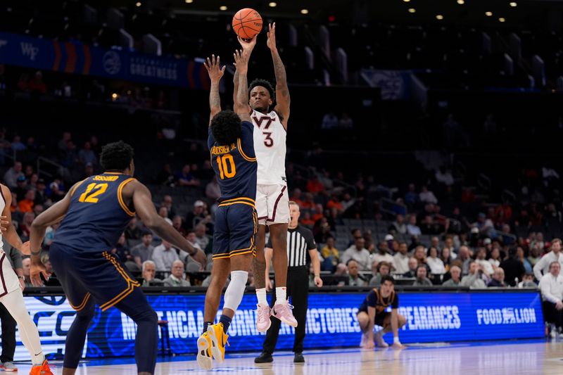 Mar 11, 2025; Charlotte, NC, USA; Virginia Tech Hokies guard Jaydon Young (3) shoots over California Golden Bears guard Jovan Blacksher Jr. (10) during the second half at Spectrum Center. Mandatory Credit: Jim Dedmon-Imagn Images