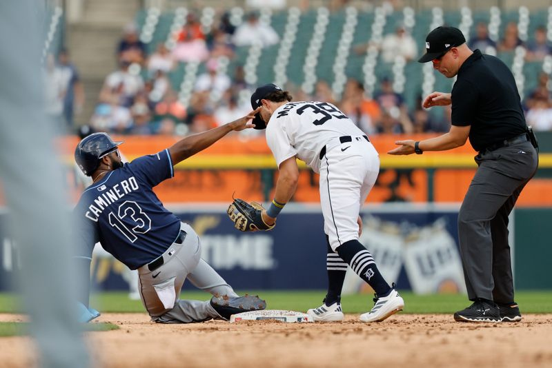 Jul 9, 2025; Detroit, Michigan, USA;  Tampa Bay Rays third baseman Junior Caminero (13) is tagged out by Detroit Tigers third baseman Zach McKinstry (39) in the third inning at Comerica Park. Mandatory Credit: Rick Osentoski-Imagn Images
