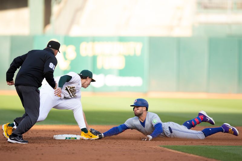 Jun 7, 2024; Oakland, California, USA; Oakland Athletics second baseman Zack Gelof (20) tags out Toronto Blue Jays center fielder Kevin Kiermaier (39) as he tries to stretch a single into a double during the third inning at Oakland-Alameda County Coliseum. Umpire is Brian Knight. Mandatory Credit: D. Ross Cameron-USA TODAY Sports