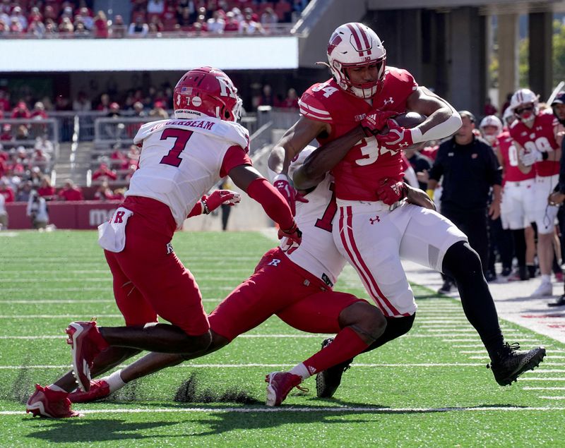 Oct 7, 2023; Madison, Wisconsin, USA; Wisconsin running back Jackson Acker (34) is tackled short of the end zone by Rutgers linebacker Mohamed Toure (1) during the fourth quarter at Camp Randall Stadium. Mandatory Credit: Mark Hoffman-USA TODAY Sports