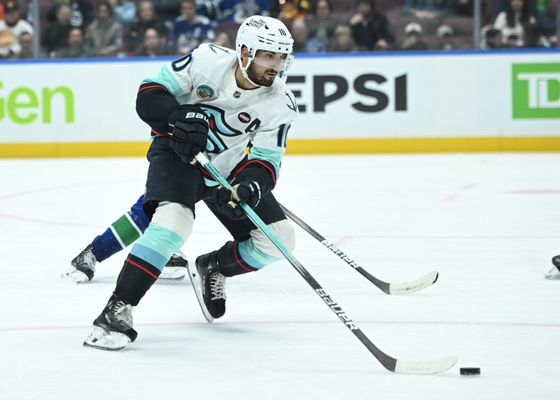 Apr 2, 2025; Vancouver, British Columbia, CAN; Seattle Kraken forward Matty Beniers (10) skates with puck against the Vancouver Canucks during the second periodat Rogers Arena. Mandatory Credit: Simon Fearn-Imagn Images