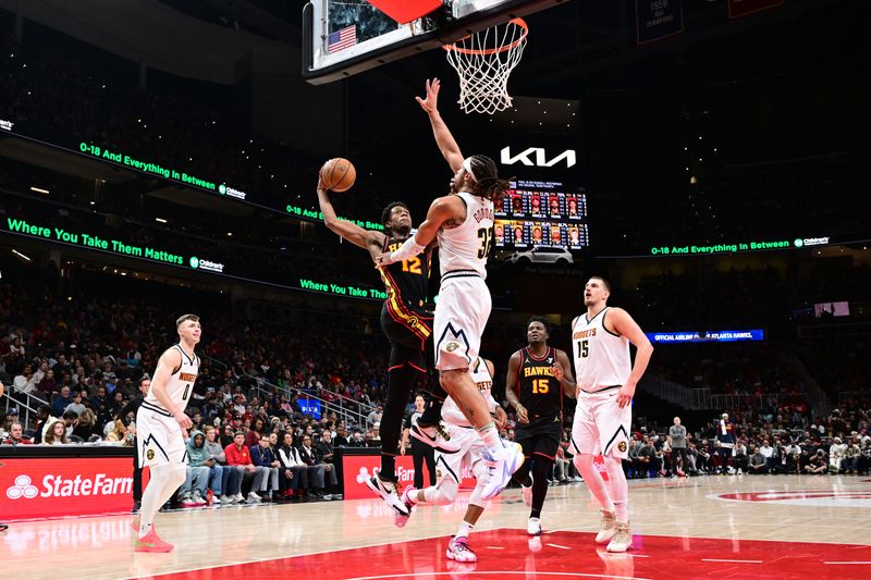ATLANTA, GA - DECEMBER 8: De'Andre Hunter #12 of the Atlanta Hawks drives to the basket during the game against the Denver Nuggets on December 8, 2024 at State Farm Arena in Atlanta, Georgia.  NOTE TO USER: User expressly acknowledges and agrees that, by downloading and/or using this Photograph, user is consenting to the terms and conditions of the Getty Images License Agreement. Mandatory Copyright Notice: Copyright 2024 NBAE (Photo by Adam Hagy/NBAE via Getty Images)