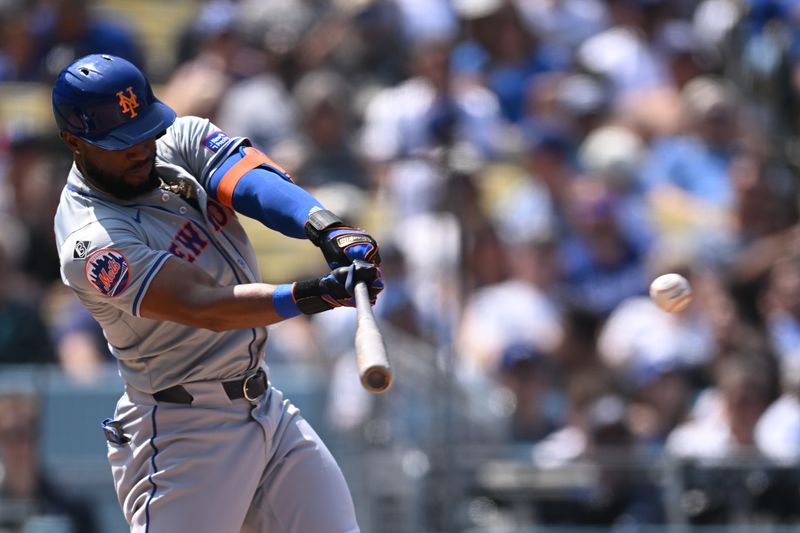 Apr 20, 2024; Los Angeles, California, USA; New York Mets outfielder Starling Marte (6) hits a one run single against the Los Angeles Dodgers during the fourth inning at Dodger Stadium. Mandatory Credit: Jonathan Hui-USA TODAY Sports