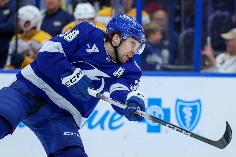 Mar 29, 2026; Tampa, Florida, USA; Tampa Bay Lightning left wing Brandon Hagel (38) shoots the puck against the Nashville Predators in the third period at Benchmark International Arena. Mandatory Credit: Nathan Ray Seebeck-Imagn Images