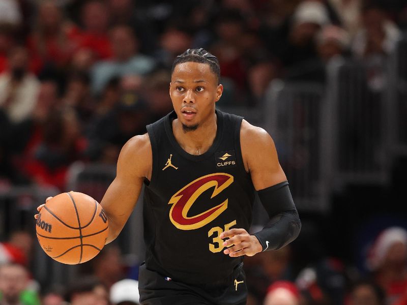 CHICAGO, ILLINOIS - DECEMBER 23: Isaac Okoro #35 of the Cleveland Cavaliers dribbles up the court against the Chicago Bulls during the first half at the United Center on December 23, 2023 in Chicago, Illinois. NOTE TO USER: User expressly acknowledges and agrees that, by downloading and or using this photograph, User is consenting to the terms and conditions of the Getty Images License Agreement.  (Photo by Michael Reaves/Getty Images)