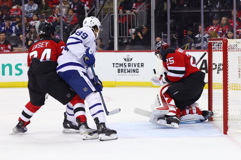 Oct 10, 2024; Newark, New Jersey, USA; New Jersey Devils goaltender Jacob Markstrom (25) makes a save against the Toronto Maple Leafs during the first period at Prudential Center. Mandatory Credit: Ed Mulholland-Imagn Images