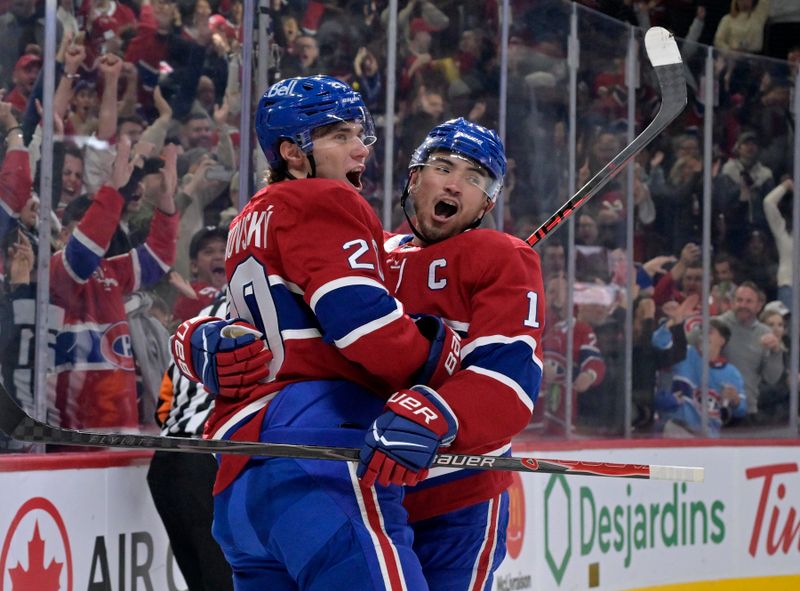 Nov 1, 2025; Montreal, Quebec, CAN; Montreal Canadiens forward Juraj Slafkovsky (20) celebrates with teammate  forward Nick Suzuki (14) after scoring a goal against the Ottawa Senators during the first period at the Bell Centre. Mandatory Credit: Eric Bolte-Imagn Images