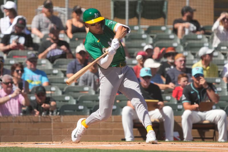 Mar 11, 2024; Salt River Pima-Maricopa, Arizona, USA; Oakland Athletics second baseman Zack Gelof (20) hits a single against the Arizona Diamondbacks in the first inning at Salt River Fields at Talking Stick. Mandatory Credit: Rick Scuteri-USA TODAY Sports