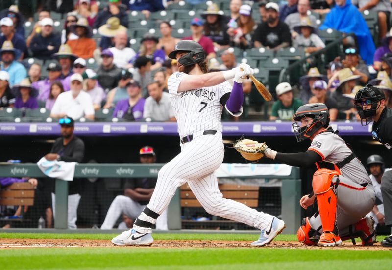 Jul 21, 2024; Denver, Colorado, USA; Colorado Rockies second base Brendan Rodgers (7) hits a two run home run in the fourth inning against the San Francisco Giants at Coors Field. Mandatory Credit: Ron Chenoy-USA TODAY Sports