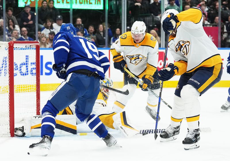 Dec 9, 2023; Toronto, Ontario, CAN; Toronto Maple Leafs center Calle Jarnkrok (19) battles for the puck with Nashville Predators defenseman Jeremy Lauzon (3) in front of goaltender Kevin Lankinen (32) during the third period at Scotiabank Arena. Mandatory Credit: Nick Turchiaro-USA TODAY Sports