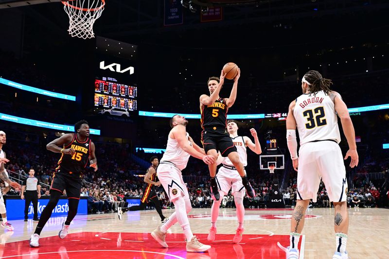 ATLANTA, GA - DECEMBER 8: Dyson Daniels #5 of the Atlanta Hawks drives to the basket during the game against the Denver Nuggets on December 8, 2024 at State Farm Arena in Atlanta, Georgia.  NOTE TO USER: User expressly acknowledges and agrees that, by downloading and/or using this Photograph, user is consenting to the terms and conditions of the Getty Images License Agreement. Mandatory Copyright Notice: Copyright 2024 NBAE (Photo by Adam Hagy/NBAE via Getty Images)