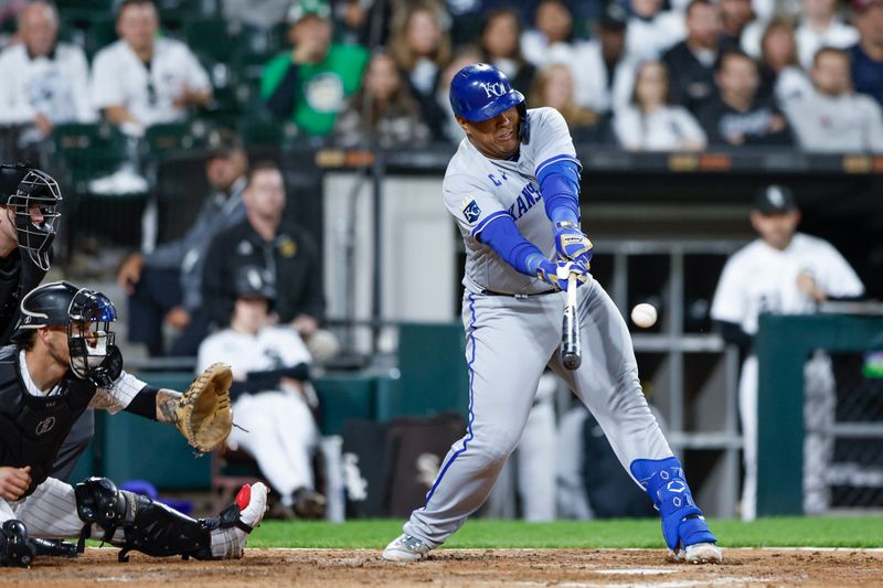 Sep 13, 2023; Chicago, Illinois, USA; Kansas City Royals catcher Salvador Perez (13) hits an RBI-single against the Chicago White Sox during the seventh inning at Guaranteed Rate Field. Mandatory Credit: Kamil Krzaczynski-USA TODAY Sports