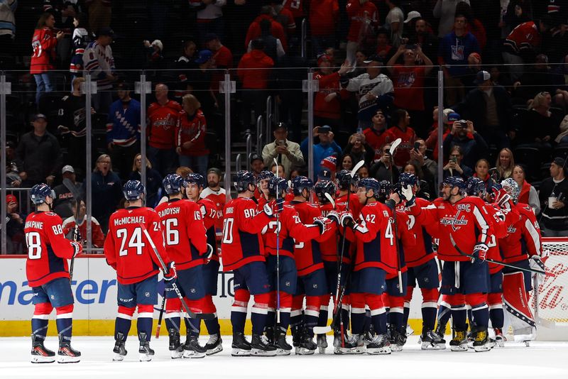 Oct 29, 2024; Washington, District of Columbia, USA; Washington Capitals players celebrate after their game against the New York Rangers at Capital One Arena. Mandatory Credit: Geoff Burke-Imagn Images