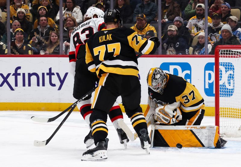 Feb 2, 2026; Pittsburgh, Pennsylvania, USA;  Pittsburgh Penguins goaltender Arturs Silovs (37) makes a save against Ottawa Senators center Stephen Halliday (83) as Pens defenseman Brett Kulak (77) defends during the second period at PPG Paints Arena. Mandatory Credit: Charles LeClaire-Imagn Images