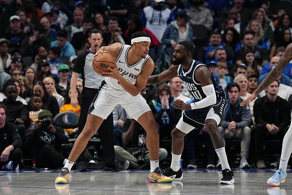 DALLAS, TX - DECEMBER 23: Keldon Johnson #3 of the San Antonio Spurs handles the ball against defender Tim Hardaway Jr. #10 of the Dallas Mavericks during the game on December 23, 2023 at the American Airlines Center in Dallas, Texas. NOTE TO USER: User expressly acknowledges and agrees that, by downloading and or using this photograph, User is consenting to the terms and conditions of the Getty Images License Agreement. Mandatory Copyright Notice: Copyright 2023 NBAE (Photo by Glenn James/NBAE via Getty Images)